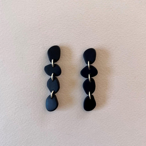 Matte black organic shaped statement earrings handmade from polymer clay by Vertseas.