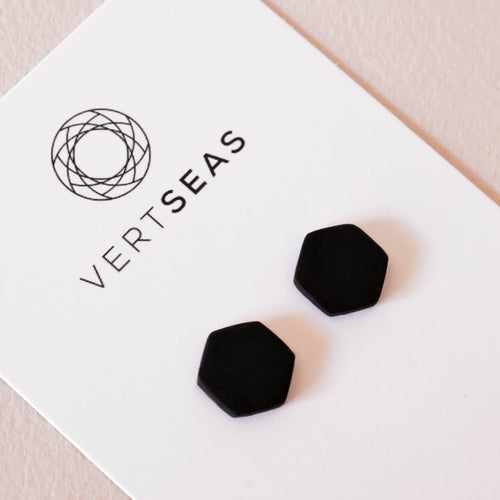 Matte black hexagon stud earrings handmade from polymer clay by Vertseas.