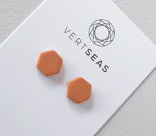 Load image into Gallery viewer, Hexagon stud earrings in terracotta colour handmade from polymer clay by Vertseas.
