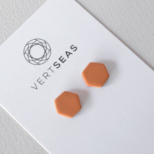 Load image into Gallery viewer, Hexagon stud earrings in terracotta colour handmade from polymer clay by Vertseas.
