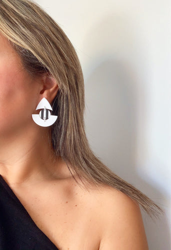 Model wearing RHEA statement earrings in black and white handmade by Vertseas