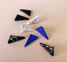 Load image into Gallery viewer, Display of triangle stud earrings in different colours handmade from polymer clay by Vertseas.
