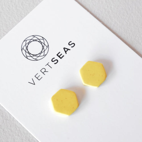 Speckled yellow hexagon stud earrings handmade from polymer clay by Vertseas.